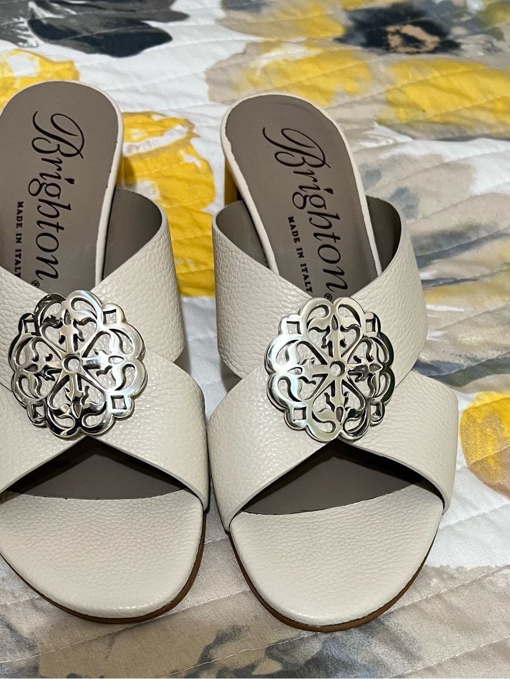 Brighton “Alison” Ivory Leather Slide Mules with Silver Medallions